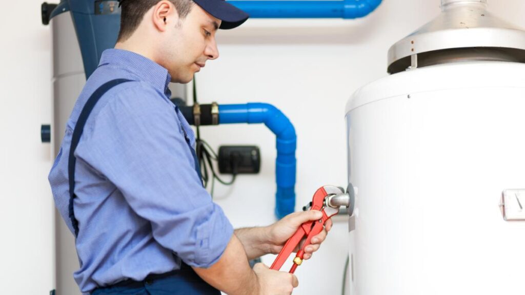 Technician repairing a hot water tank.