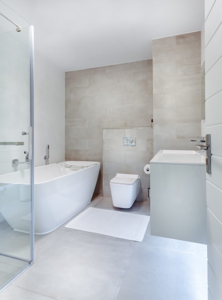 all-white bathroom with a large soaker tub.