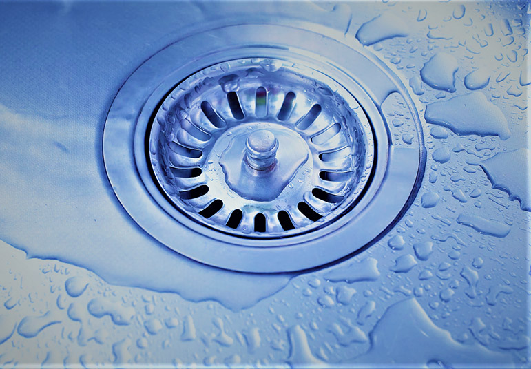 Close-up of water flowing down a drain.