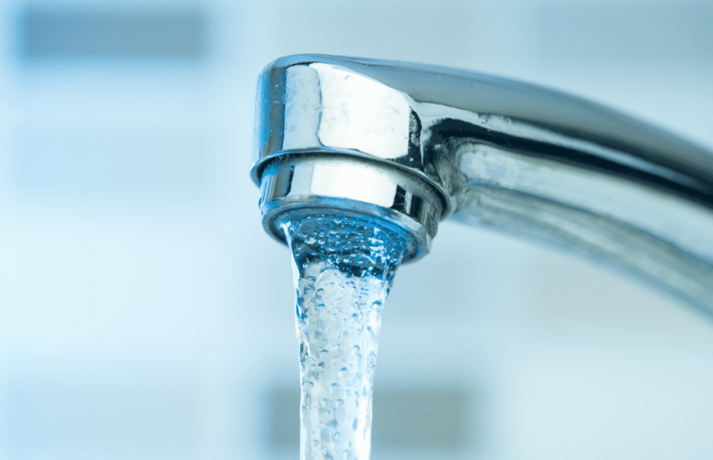 Close-up of a faucet with water running out of it.